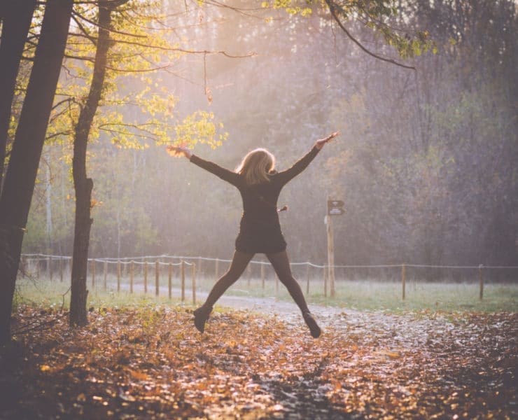 girl jumping in autumn