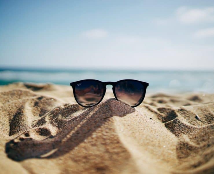 summer time sun glasses on sand