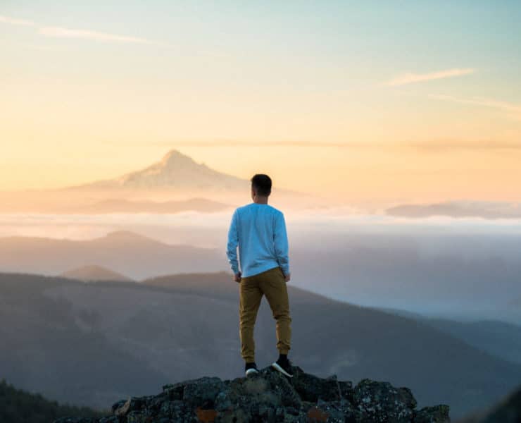 man standing on mountain stop