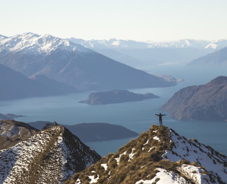 person standing on mountain top