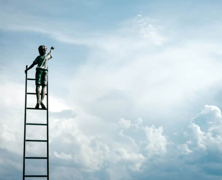 boy on ladder in sky
