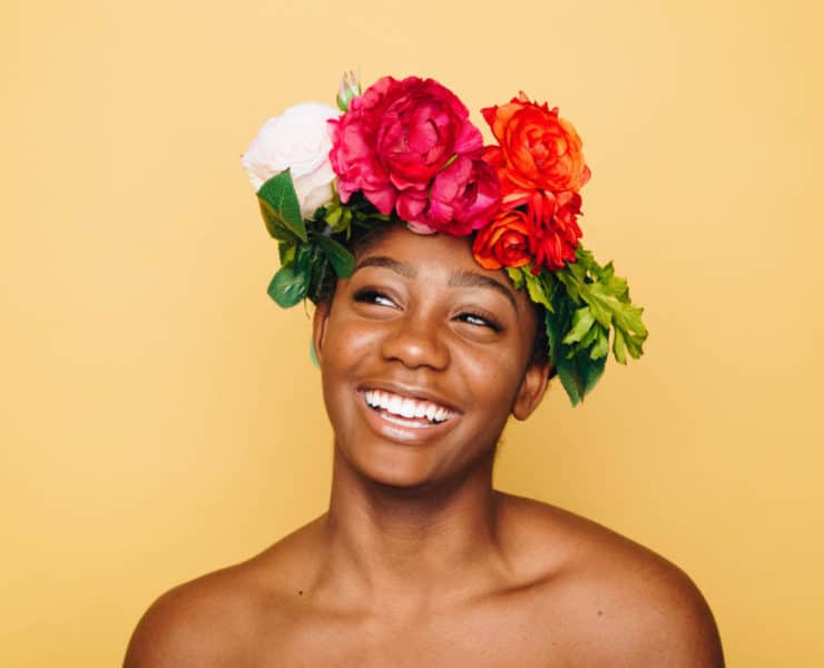 girl smiling with flowers in hair