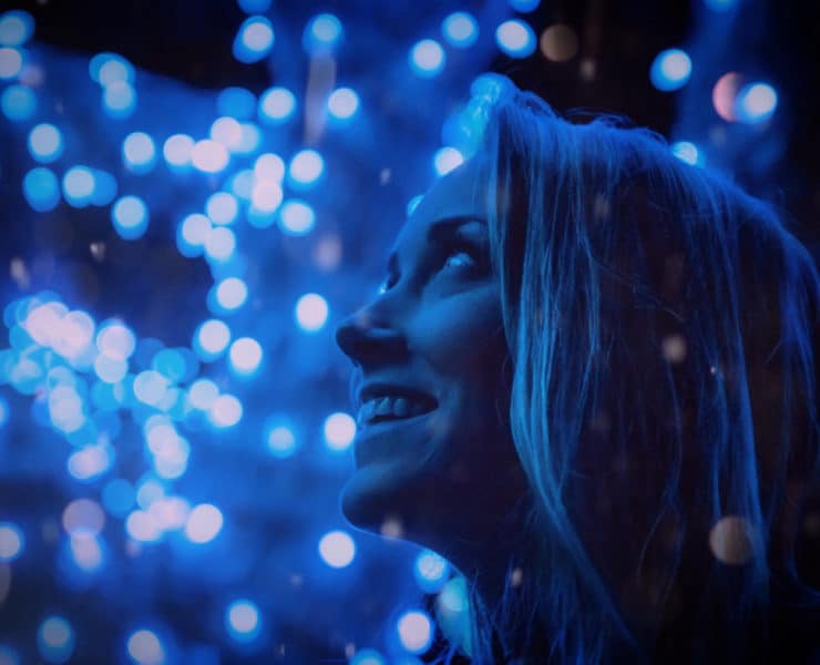 girl amazed by blue lights
