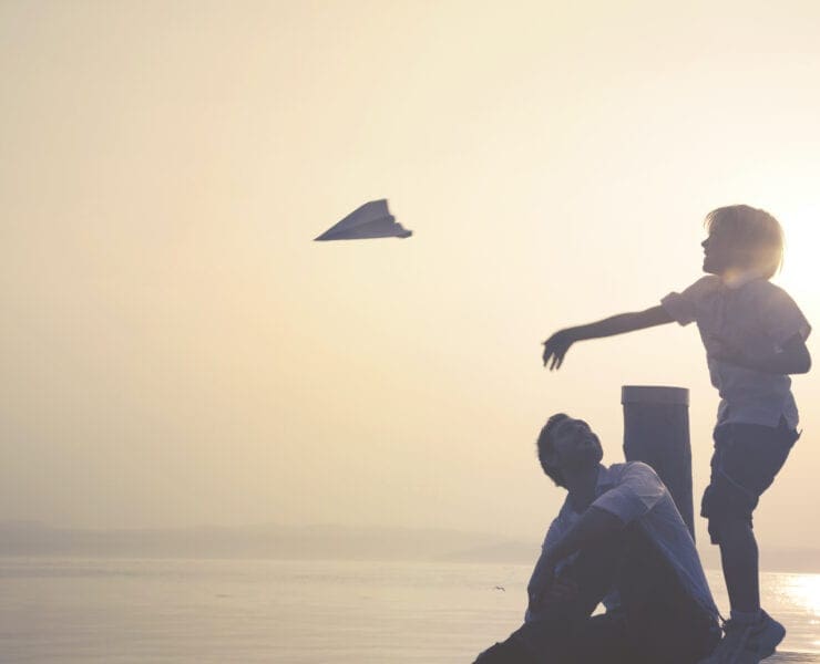 Child throwing paper plane