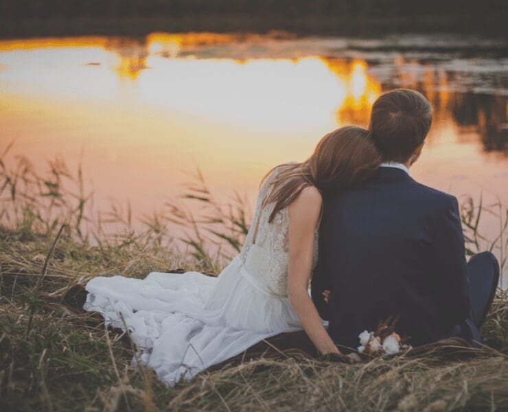 Married couple sitting by the lake