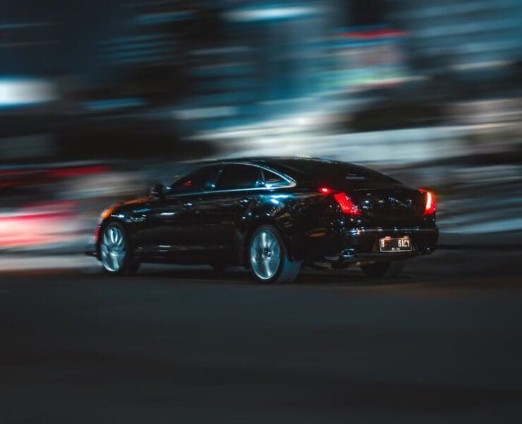 Car fleeing through the city at night with motion blur
